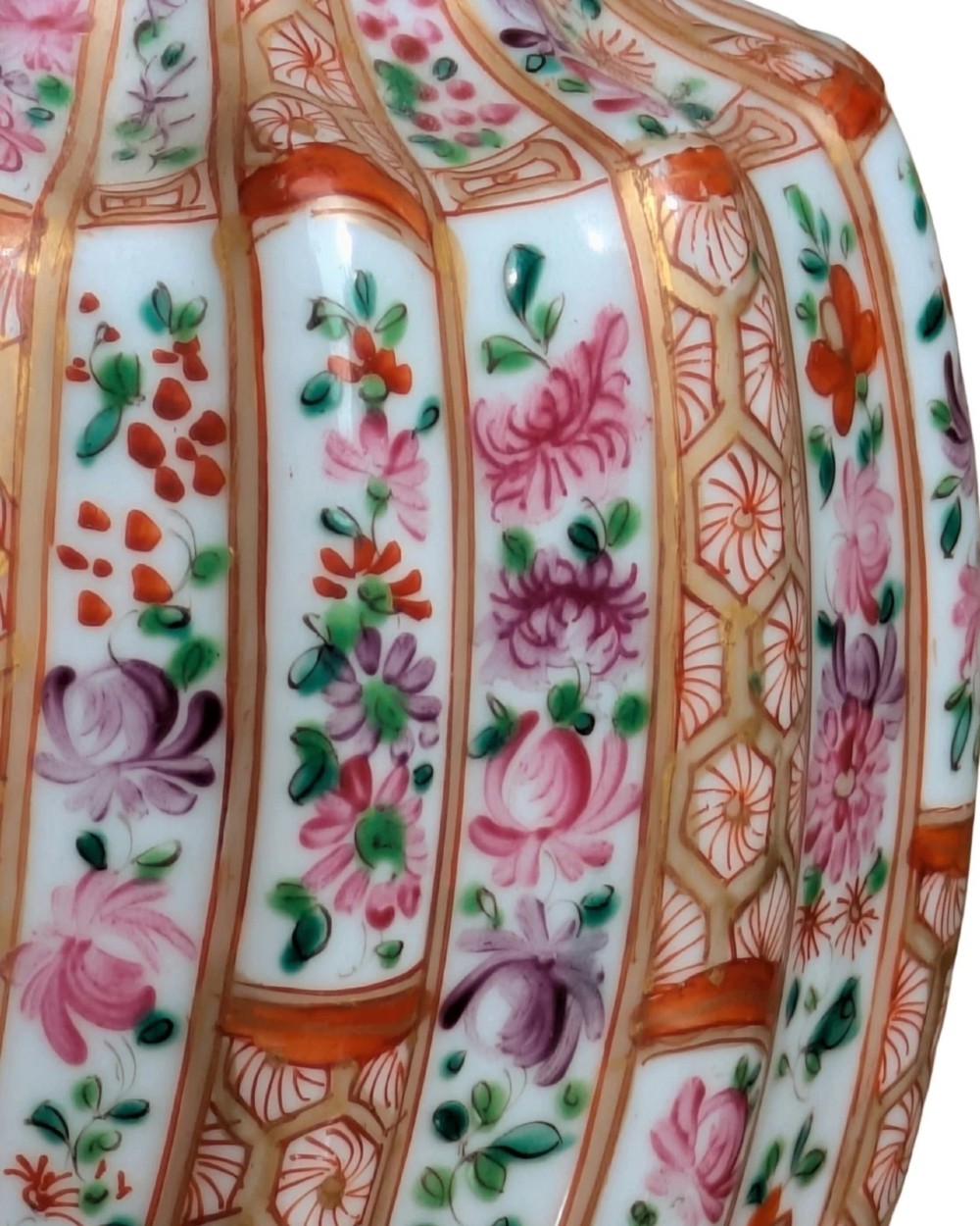 A pair of hand-painted porcelain lidded vases featuring fluted bodies, intricate floral motifs, geometric orange bands, and gilded details on square pedestals. View VII