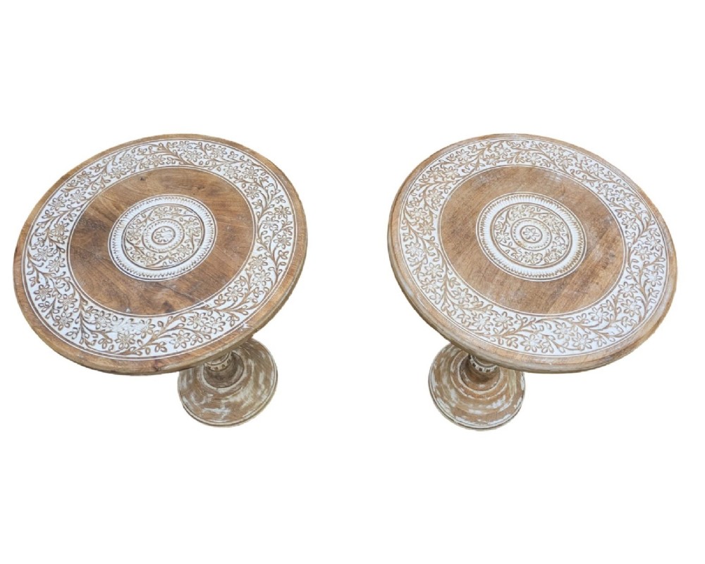 A pair of round carved wooden pedestal side tables featuring hand-painted whitewashed concentric floral patterns on the tops and turned bases. View II
