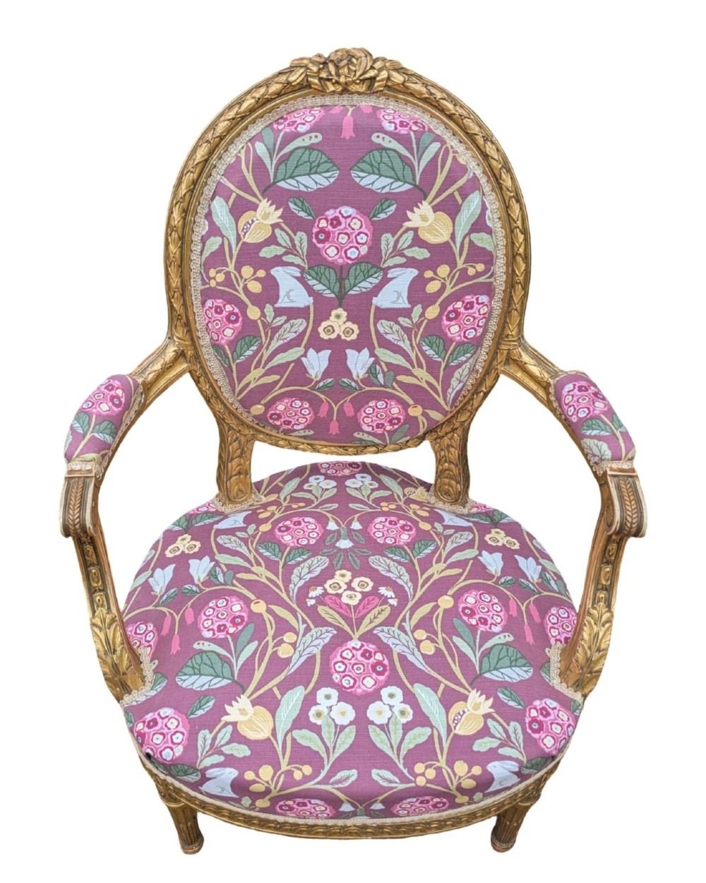 A pair of carved giltwood French armchairs featuring oval medallion backs and floral patterned plum-coloured upholstery. View IV