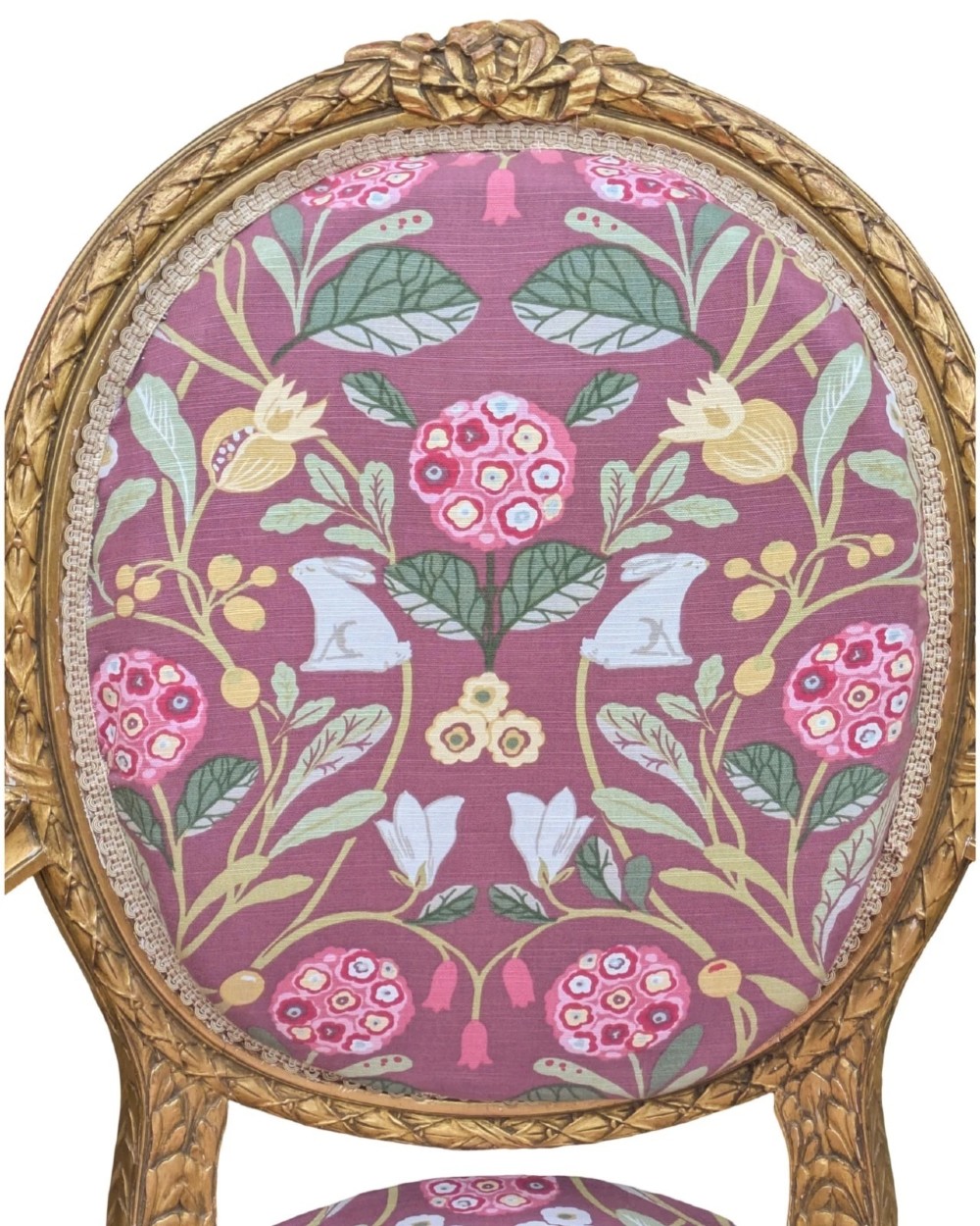 A pair of carved giltwood French armchairs featuring oval medallion backs and floral patterned plum-coloured upholstery. View VII