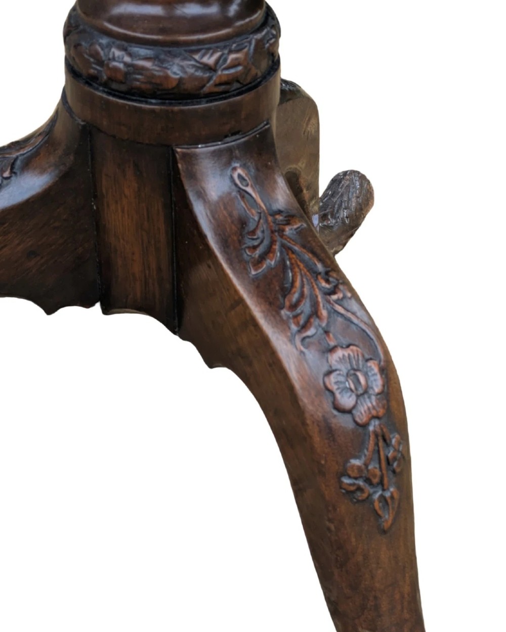 A Georgian mahogany tilt-top table with a scalloped piecrust edge shown in a raised vertical position above a turned pedestal and carved tripod cabriole legs. View V