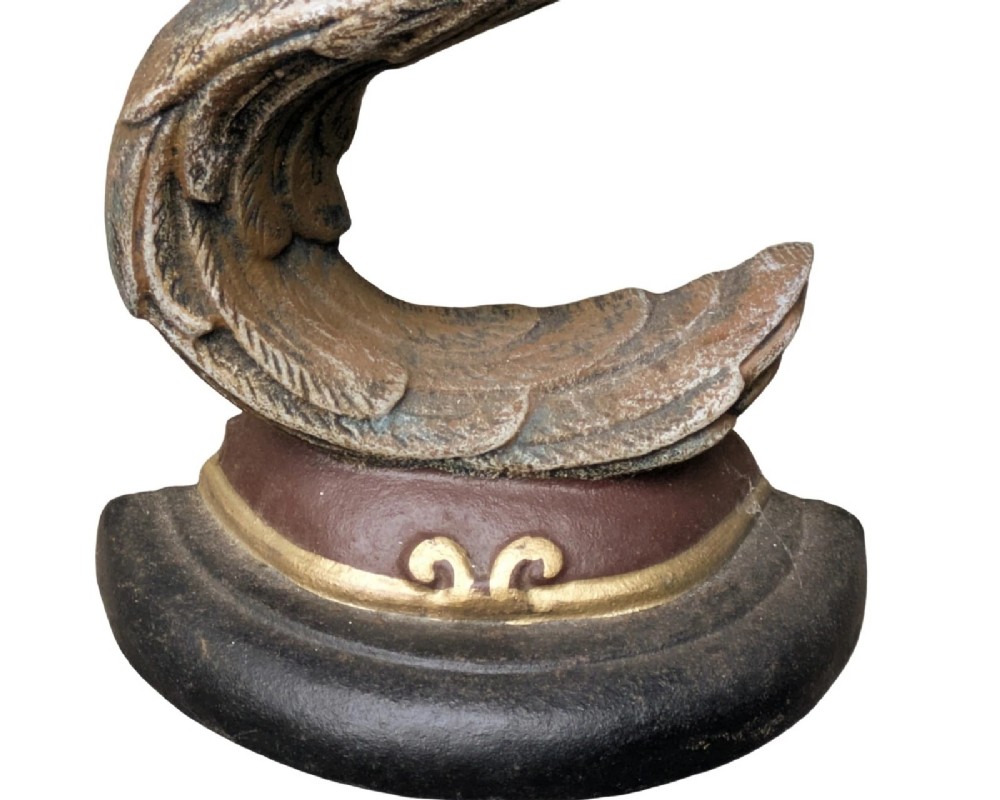 A cast iron doorstop styled as a sculpted eagle head resting on a stylized curved feather base set upon a round plinth. View IV