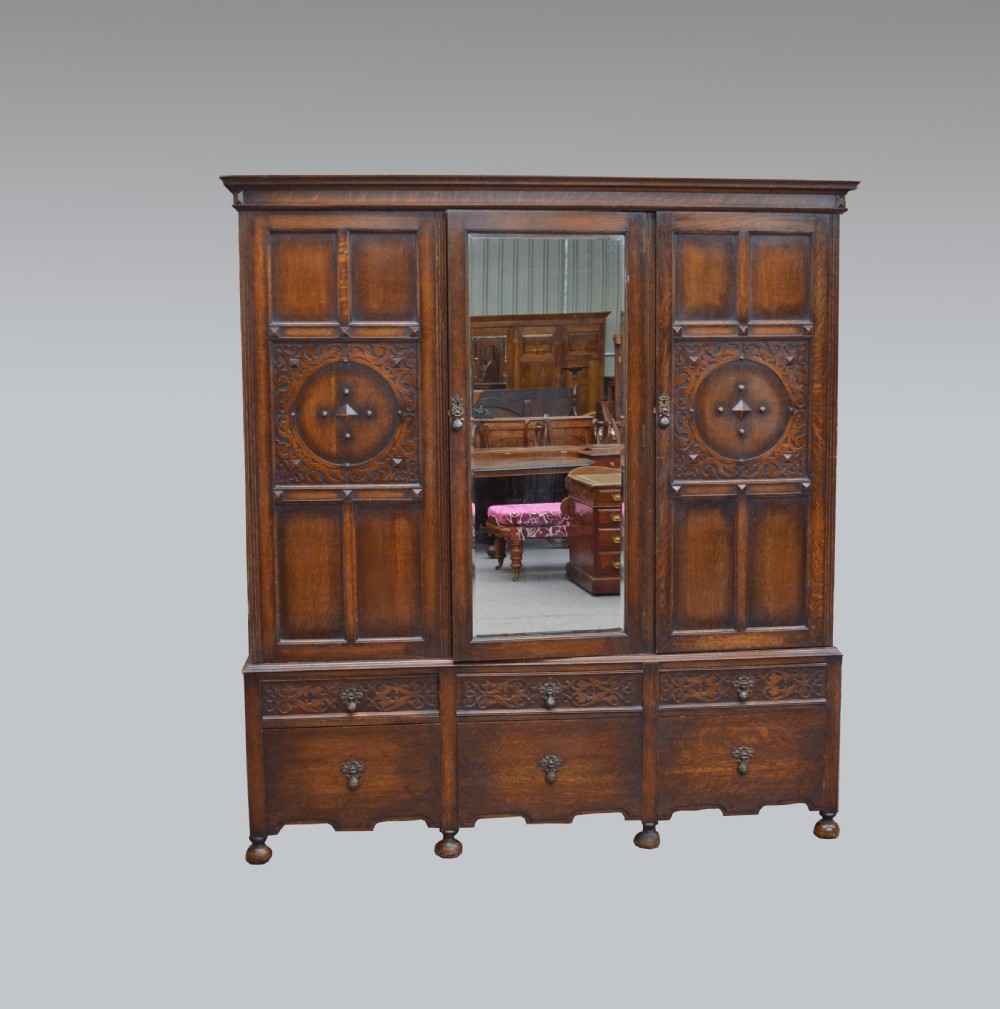 Oak Jacobean style triple wardrobe 