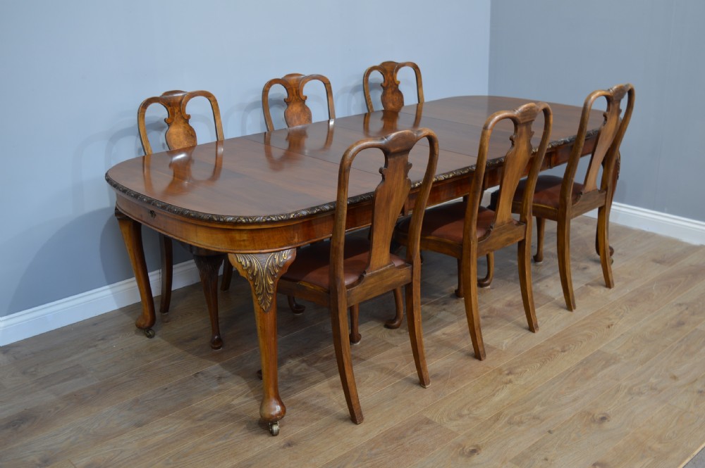Antique walnut two leaf wind out dining table and 6 chairs by Merryweather of Holloway London 