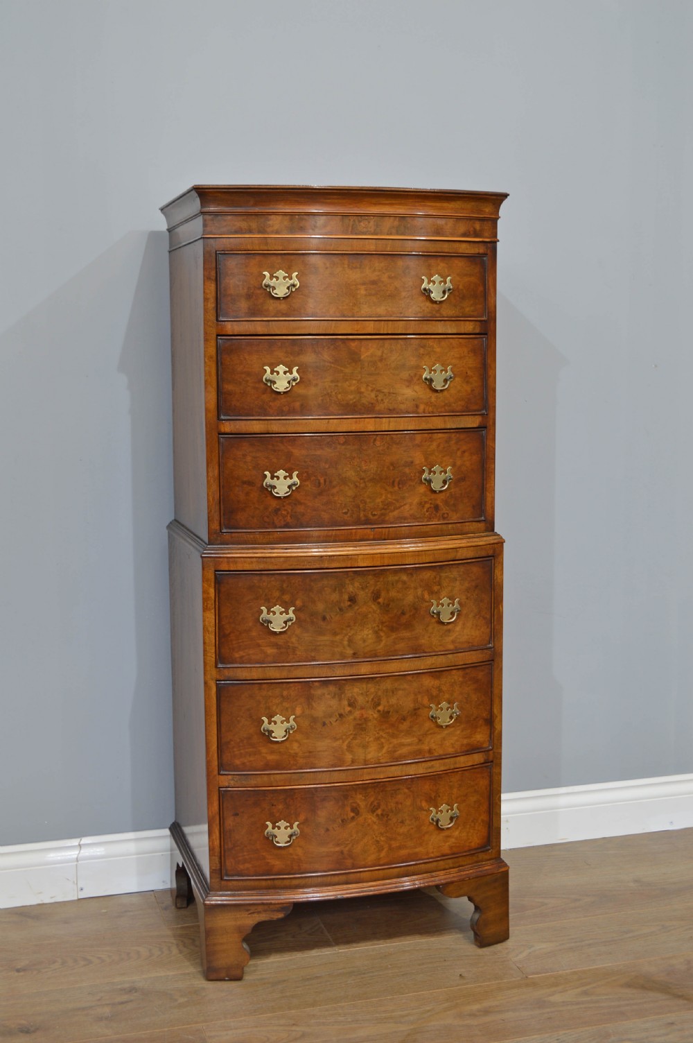 small walnut bow front chest on chest 