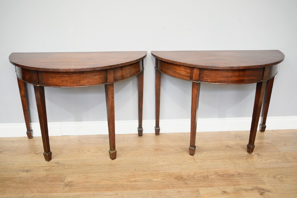pair of antique Georgian mahogany deme-lune console hall tables