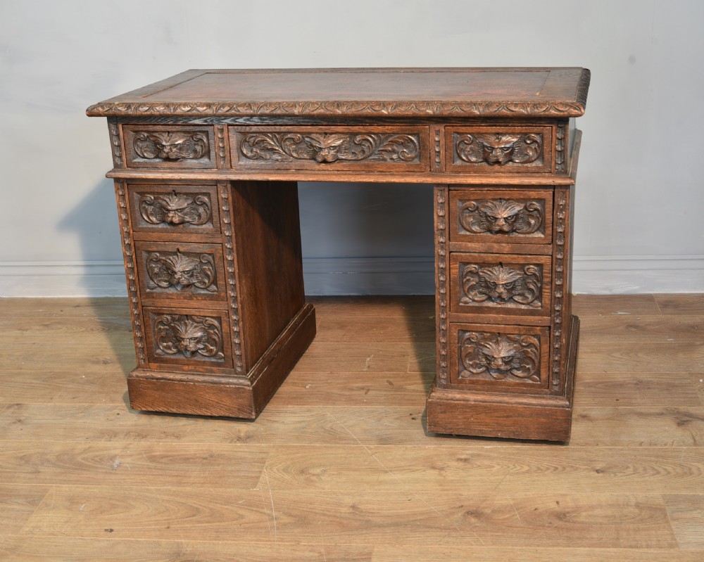 Carved oak greenman pedestal desk 