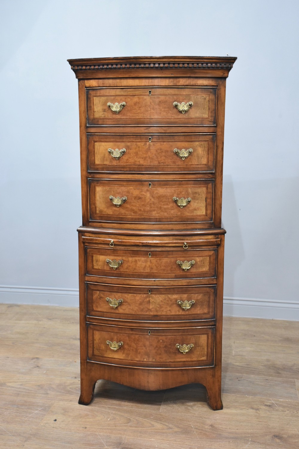 Walnut bow front chest on chest 