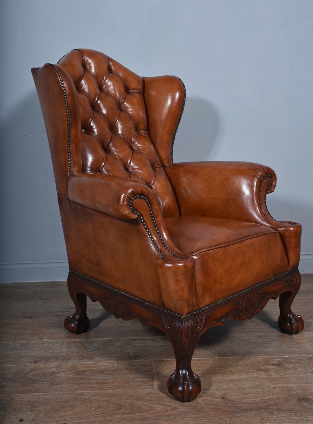 large antique deep buttoned antique leather wing chair  View II