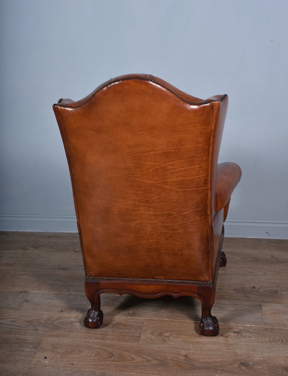 large antique deep buttoned antique leather wing chair  View III