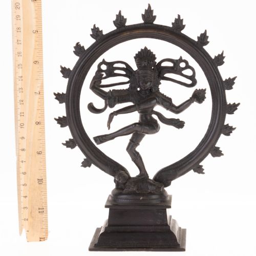 fig 3. A dark patinated bronze sculpture depicting the Hindu deity Shiva Nataraja as the cosmic dancer encircled by a flaming halo atop a tiered square pedestal.