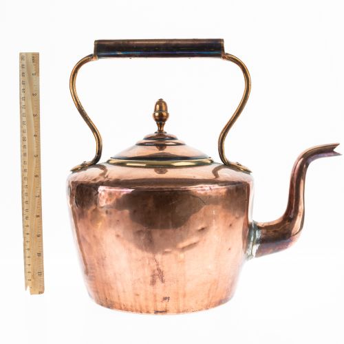 fig 2. A 19th-century Victorian copper kettle featuring a brass rim lid, finial top, gooseneck spout, and fixed overhead handle.