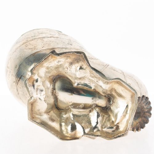 fig 2. A Victorian silver-plated spoon warmer fashioned in the shape of a nautilus shell with engraved detailing and a hinged lid, resting on a textured base.