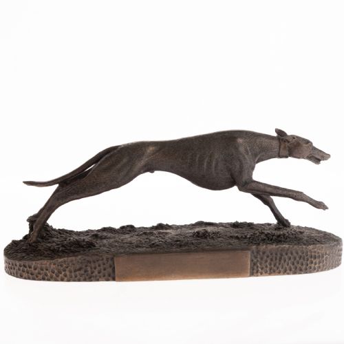 fig 2. A dark patinated bronze sculpture capturing a greyhound in full stride mounted on a textured oval base.