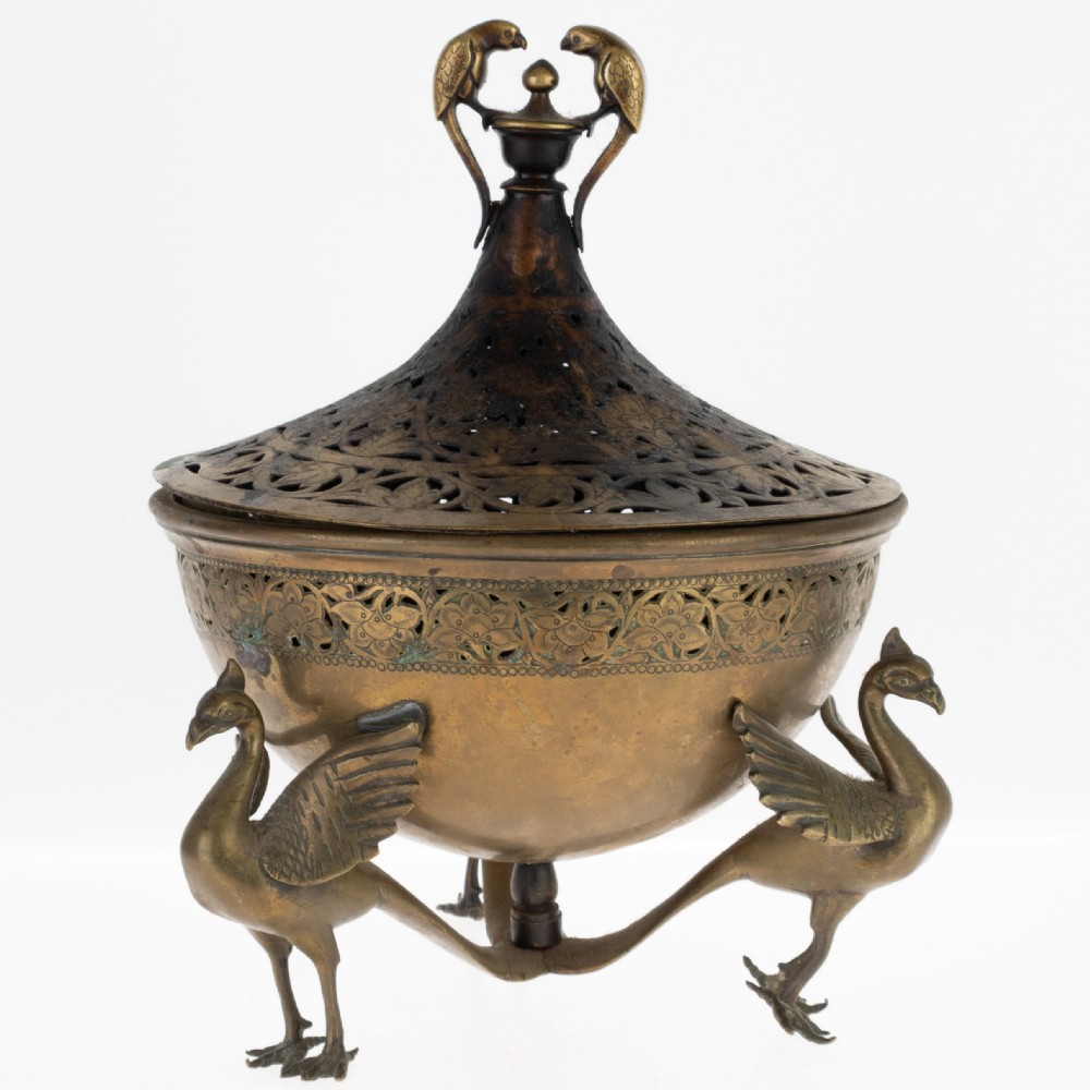 An antique Indian bronze incense burner with a pierced domed lid, twin bird top finials, and three bird-shaped tripod legs.