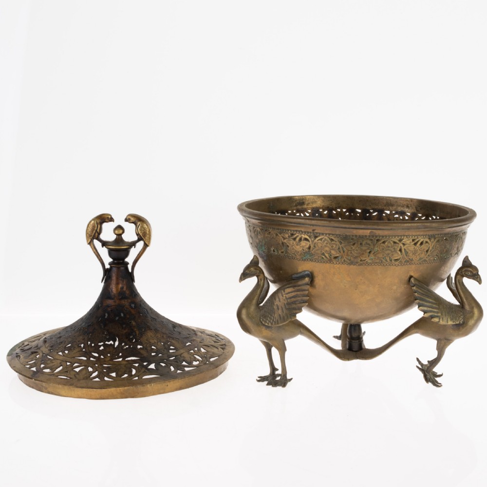 An antique Indian bronze incense burner with a pierced domed lid, twin bird top finials, and three bird-shaped tripod legs. View IV