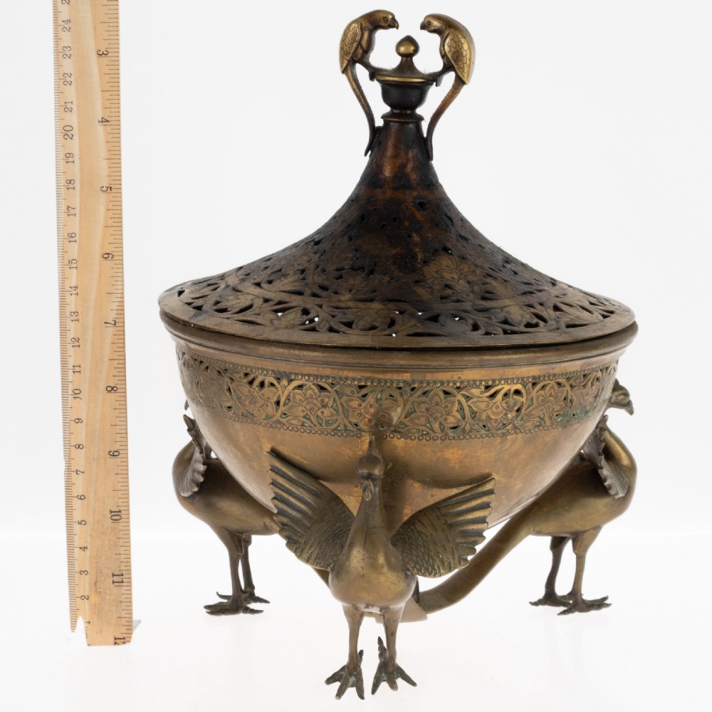 An antique Indian bronze incense burner with a pierced domed lid, twin bird top finials, and three bird-shaped tripod legs. View V