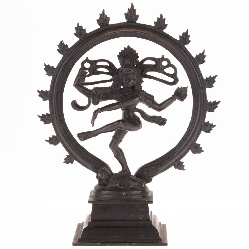 A dark patinated bronze sculpture depicting the Hindu deity Shiva Nataraja as the cosmic dancer encircled by a flaming halo atop a tiered square pedestal.