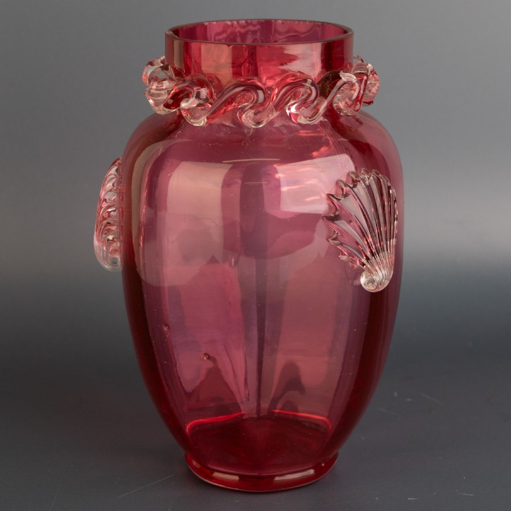 A Victorian hand-blown cranberry glass vase featuring an applied clear glass shell motif on the front and a crimped clear glass collar around the neck. View III