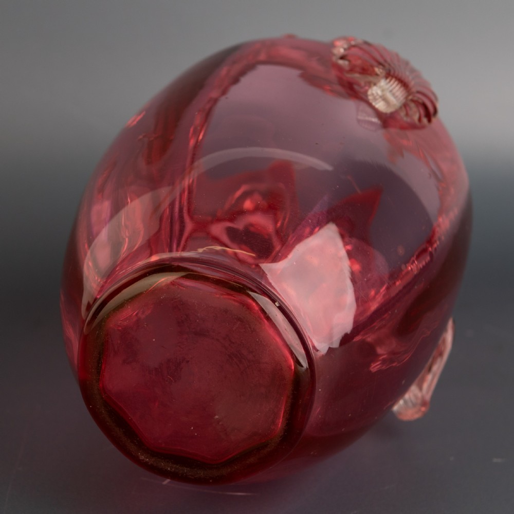 A Victorian hand-blown cranberry glass vase featuring an applied clear glass shell motif on the front and a crimped clear glass collar around the neck. View V