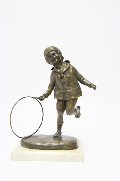 A Delightful Bronze Study of a Young Boy Playing with a Hoop and Stick