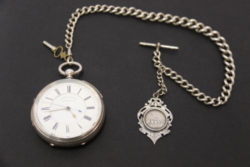 An Over Sized Silver Chronograph Pocket Watch and Chain with Mining Tug of War Fob.