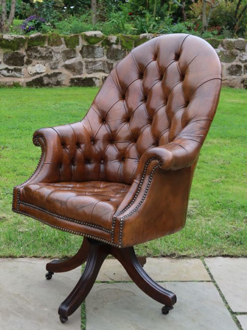 An English Tilt and Rotate Desk/study Armchair Upholstered in Original Deep Buttoned Leather.