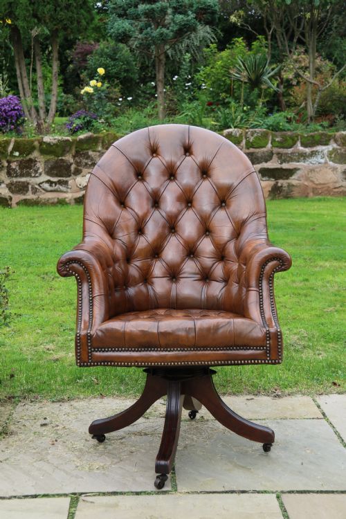 fig 1. An English tilt and rotate desk/study armchair upholstered in original deep buttoned leather.