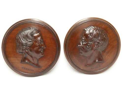 fig 1. A pair of circular carved mahogany wall plaques featuring raised profile relief busts of classical composers Rossini and Auber.