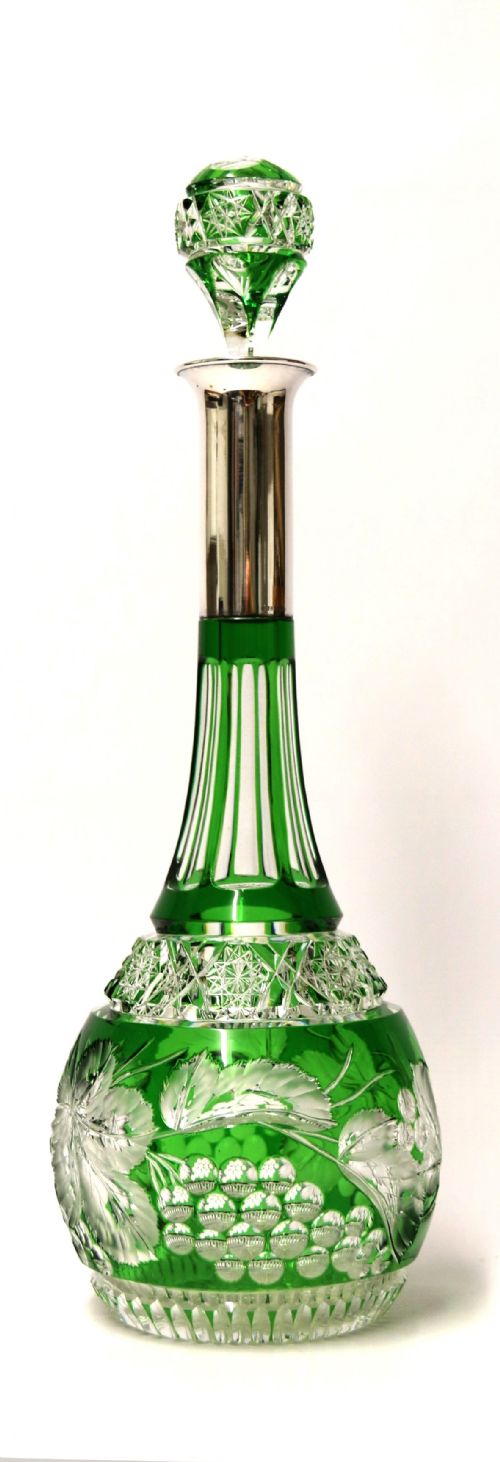 A Bohemian Silver Topped Green Overlaid and Deeply Cut and Carved Glass Spirit Decanter.