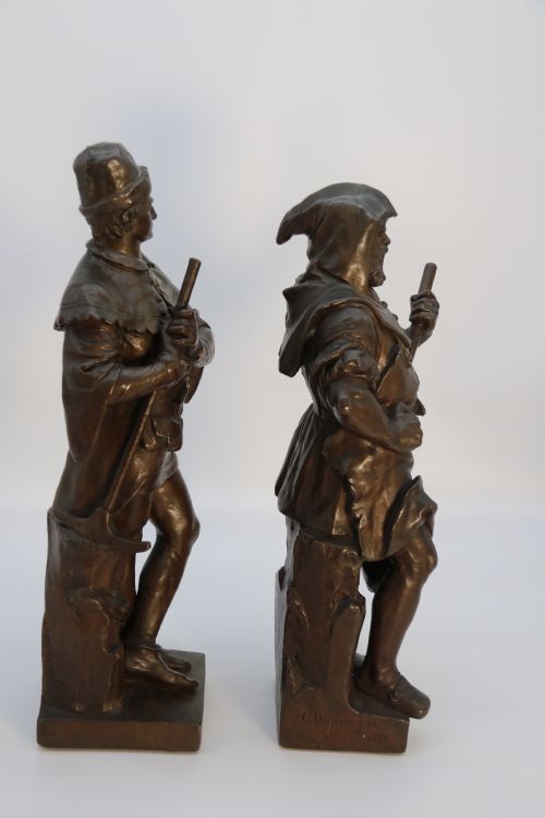 fig 1. A pair of patinated electrotype bronze figures depicting historic tradesmen standing on rectangular plinths.