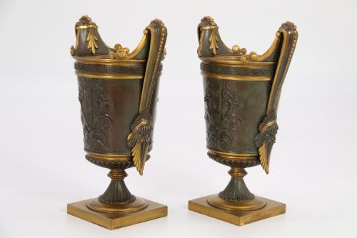 fig 2. A pair of French Empire patinated and gilt bronze urns with Greek key friezes, scroll handles, and square bases.
