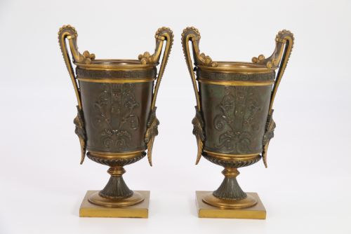 fig 3. A pair of French Empire patinated and gilt bronze urns with Greek key friezes, scroll handles, and square bases.