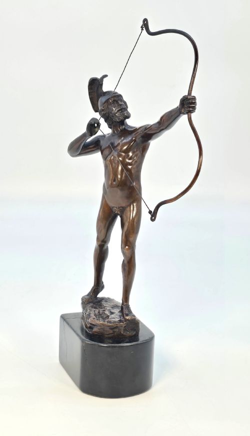 fig 1. A dark bronze sculpture of a bearded Greek archer wearing a helmet and drawing a bow, mounted on a dark stone base.