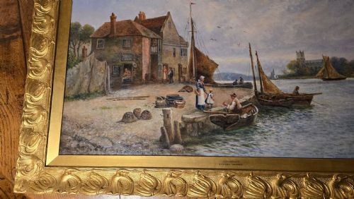 fig 2. An oil painting depicting a harbour scene with sailboats and buildings, encased in a carved gold gilt frame.