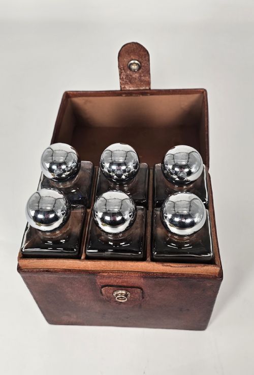 fig 1. A six bottle spirit decanter set in a fitted leather case originally used when hunting or shooting.