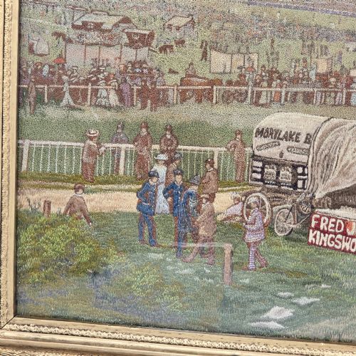 fig 3. A framed rectangular silk needlework picture depicting figures gathered at the Epsom racecourse within an ornate gilded frame.