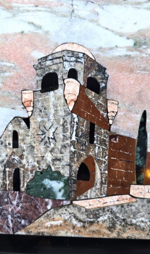 fig 2. A framed Italian pietra dura panel depicting a stone building and cypress trees rendered in inlaid coloured marble.