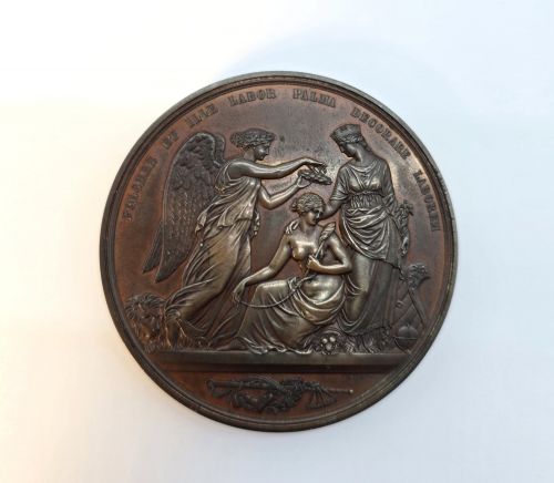 fig 1. A circular dark bronze Victorian medal displaying jugate profile portraits of Queen Victoria and Prince Albert surrounded by Latin text.