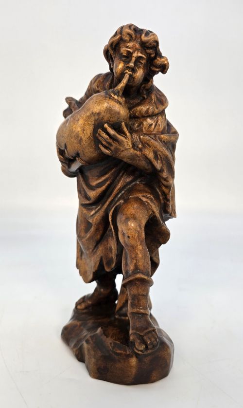 A BLACK FOREST LIMEWOOD CARVED FIGURE OF A MEDIEVAL YOUNG MAN PLAYING SWISS BAGPIPES - ADDITIONAL PHOTO 1