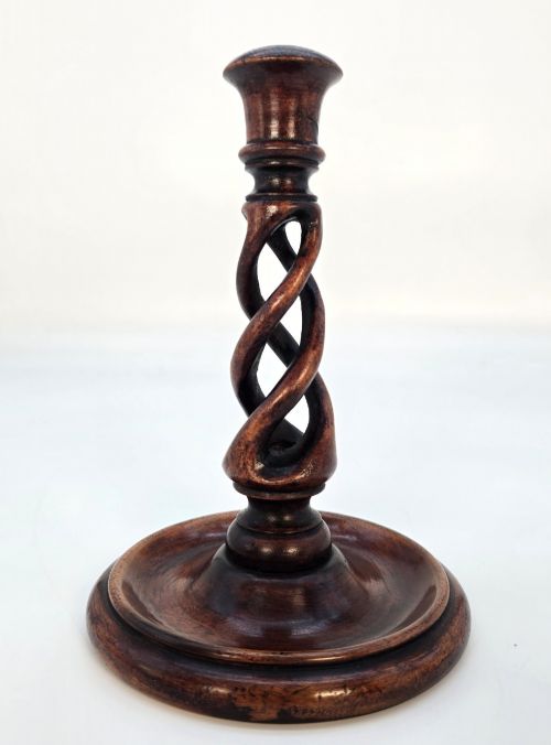 fig 2. A pair of 18th-century carved fruitwood candlesticks featuring open twist stems and wide circular bases.
