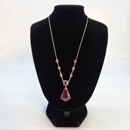 fig 1. An Art Deco style silver chain necklace featuring faceted pink crystal bicone beads and a geometric triangular crystal pendant drop.