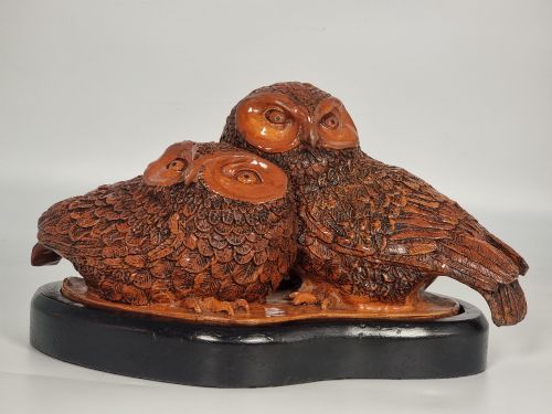 A Pair of Hand Sculpted Pottery Owls on a Ebonised Base