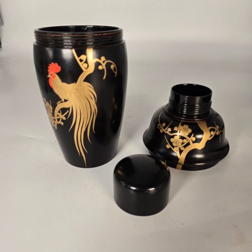 fig 4. A black and gold hand-painted Japanese lacquer cocktail set comprising a shaker, six stemmed glasses, and a rectangular tray adorned with rooster motifs.