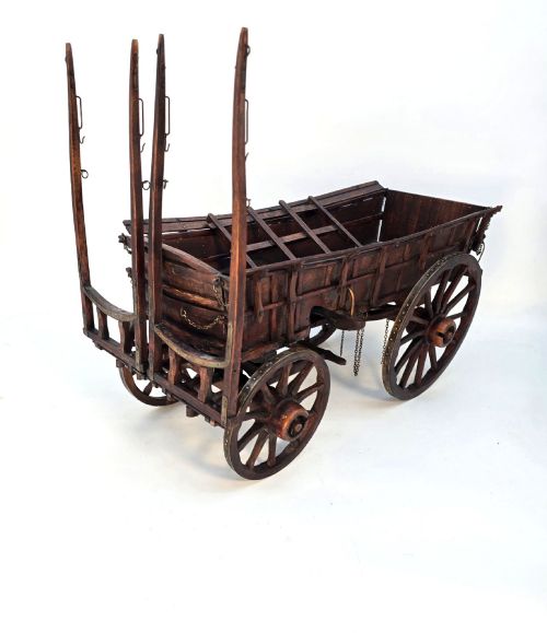 fig 1. A detailed dark wood scale model of an English twin horse-drawn farm hay cart featuring spoked wheels, iron hardware, and wooden shafts.