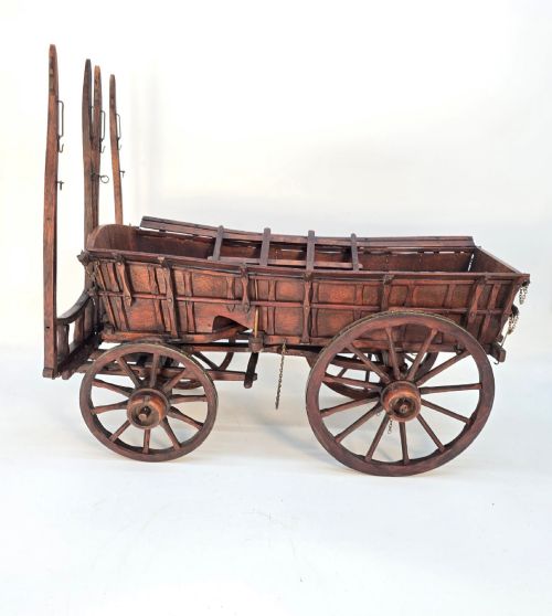 fig 2. A detailed dark wood scale model of an English twin horse-drawn farm hay cart featuring spoked wheels, iron hardware, and wooden shafts.