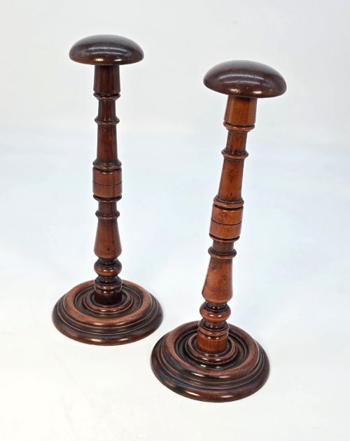 fig 2. A pair of turned early eighteenth-century yew wood wig stands featuring domed tops, knopped baluster shafts, and turned circular bases.