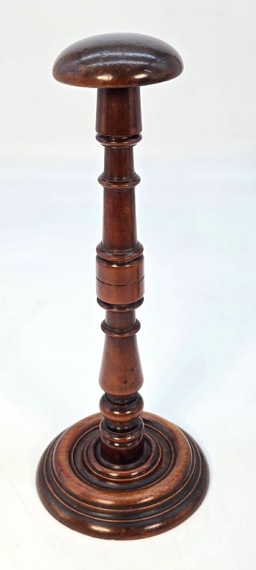 fig 3. A pair of turned early eighteenth-century yew wood wig stands featuring domed tops, knopped baluster shafts, and turned circular bases.