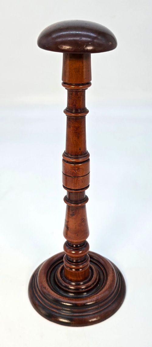A pair of turned early eighteenth-century yew wood wig stands featuring domed tops, knopped baluster shafts, and turned circular bases. View IX