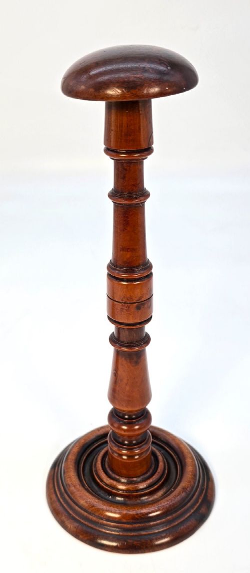 A pair of turned early eighteenth-century yew wood wig stands featuring domed tops, knopped baluster shafts, and turned circular bases. View X